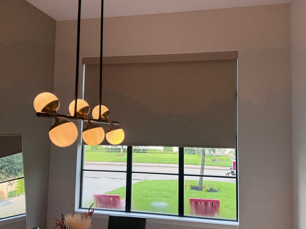 Contemporary Norman Motorized Room Darkening Roller Shades Over Entry Window on Briarmead Dr in Houston, TX