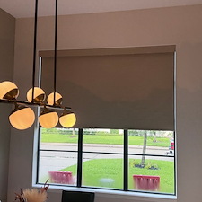 Contemporary-Norman-Motorized-Room-Darkening-Roller-Shades-Over-Entry-Window-on-Briarmead-Dr-in-Houston-TX 0